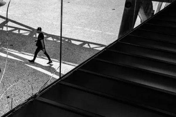 Man Walking in Strong Shadows by Fernando Alves
