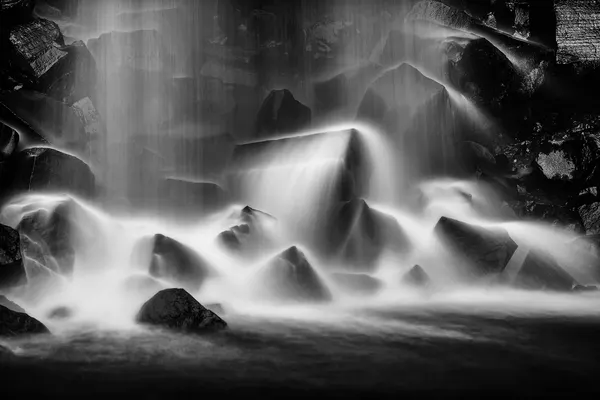Flowing Waterfall Rocks by Hervé Loire