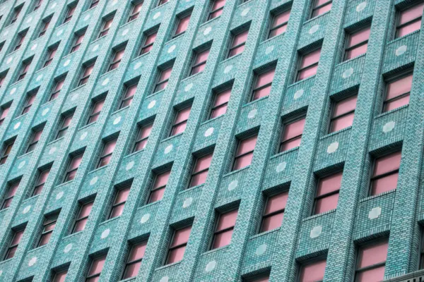 Brick Building with Pink Windows by Tom Windeknecht