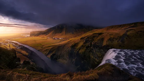 Dramatic Iceland Waterfall Sunset by Iván Ferrero