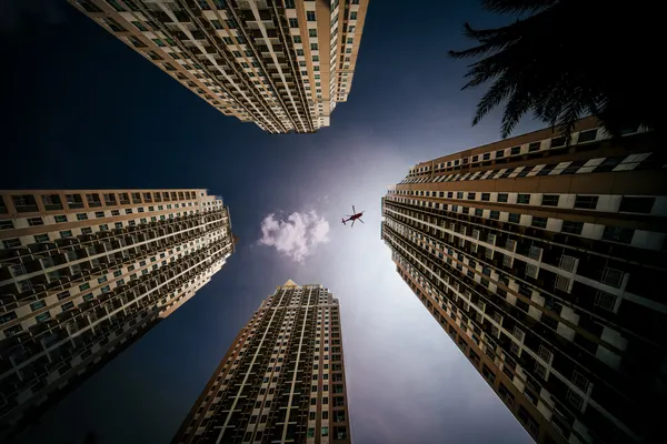 Helicopter Over Skyscrapers by Martin Wong