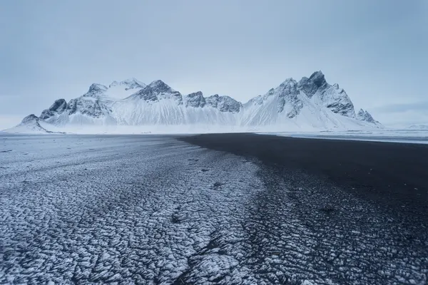 Snowy Peaks Black Beach by Paolo Stoppani