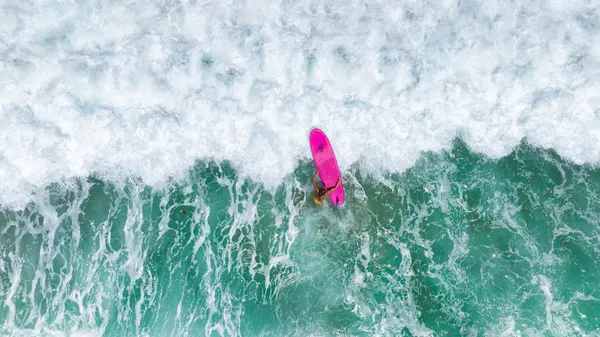 Pink Surfboard Ride by Ido Meirovich