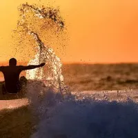 Surfer Rides Sunset Wave, wall art by Eyal Bussiba